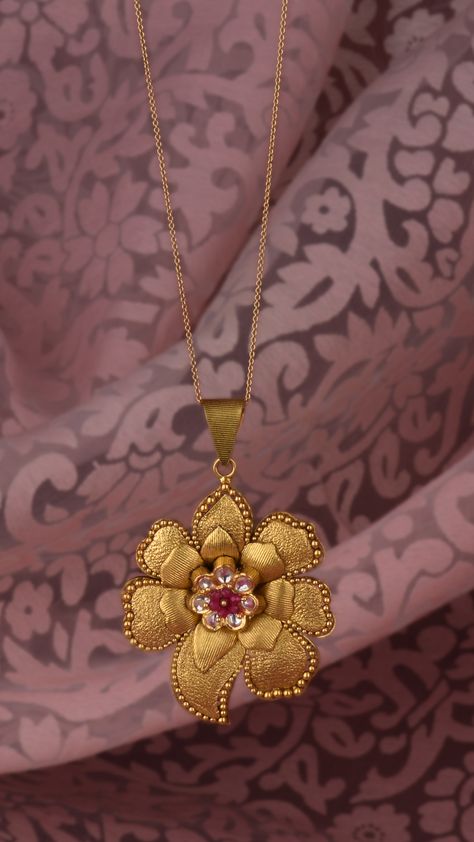 Floral pendant with gold petals and vibrant beads perched in the centre Gold Pendant Jewelry Simple, Gold Chain Pendant Designs, Chain Pendant Designs Gold, Gold Pendant Jewelry Indian, Pendent Designs Gold, Polki Diamond Jewellery, Gold Pendant Designs, Gold Pendent, Gold Jewelry Outfits