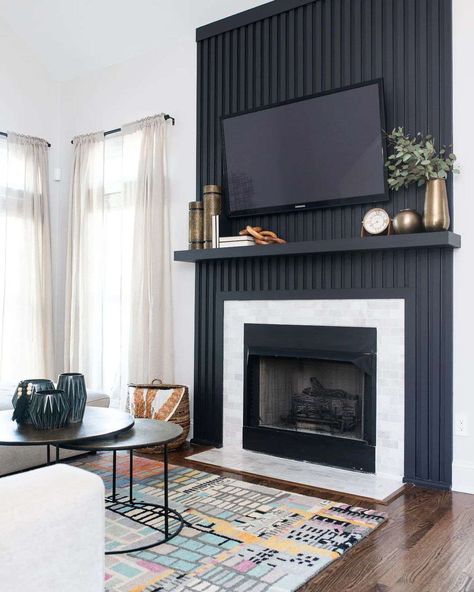 These Sophisticated Black Accent Walls Will Make an Impact in Any Space Wood Panel Walls Fireplace, Black And Wood Fireplace Wall, Black Slat Wall Fireplace, All Black Fireplace Wall, Iron Ore Fireplace Wall, Updating Fireplace, Black Modern Fireplace, Modern Black Fireplace, Batman House