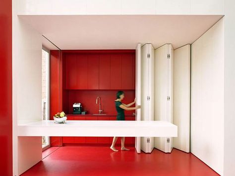 Photos of Folding Doors For Small Spaces collapsible walls for upstairs kitchen Doors For Small Spaces, Red And White Kitchen, Moving Walls, Micro Apartment, Hidden Kitchen, Folding Walls, Space Saving Kitchen, Vogue Uk, Interior Kitchen