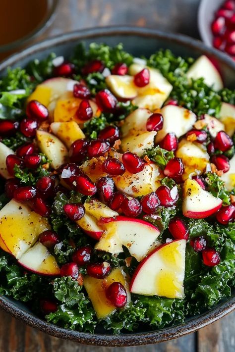 Delicious Kale and Pomegranate Salad topped with Maple Vinaigrette, perfect for festive occasions. Celebrate Thanksgiving or Christmas with this refreshing yet hearty recipe using fresh ingredients. Massage Kale Salad, Kale Pomegranate Quinoa Salad, Salads With Almonds, Half Baked Harvest Kale Salad, Easy Paleo Salad, Pomogranette Salads, Veggie Only Salad, Hearty Kale Salad, Holiday Salad With Pomegranate