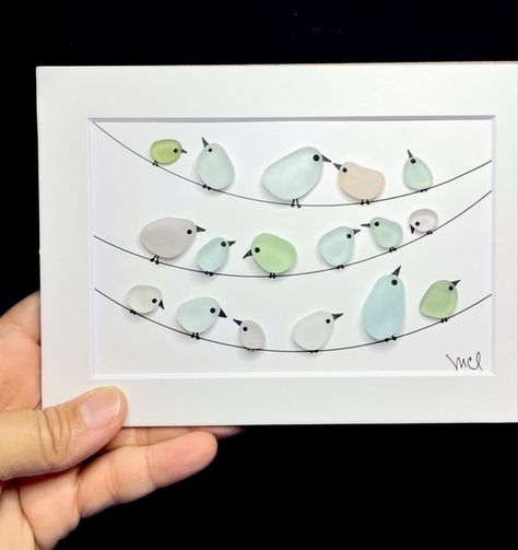 Sea Glass Art by Cristina Lugo on Instagram: "My faithful friends since I started this creative journey, the birds on the wire. My favorite part is  that every one has a personal interpretation of the scene. This time, my friends are framed inside a grey 5x7 shadow box and, they are available. If you want more information about them, just message me privately. #birdsonawire #pajarosenelalambre #birds #pajaritos #birdneighborhood #lavecindad #seaglass #vidriodemar #cristaldeplaya #madeinpuertorico #puertoricoseaglass #hechoenpuertorico #seaglasspuertorico #beachhousedecor #beachstyle #casadeplaya #cuteart" Sea Glass Bird Art, Seaglass Art Ideas, Seaglass Birds, Seaglass Ideas, Sea Glass Art Diy, Sea Glass Art Projects, Glass Art Projects, Sea Glass Crafts, Creative Craft