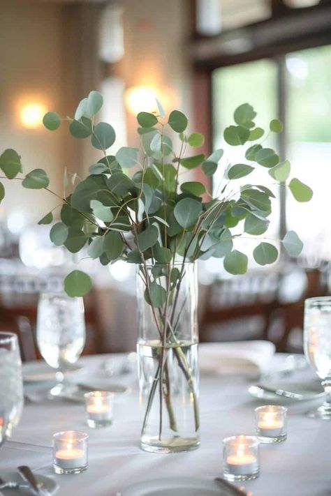 12 Beautiful Eucalyptus Centerpieces For Your Big Day • Eucalyptus Wedding Centrepiece, Eucalyptus Wedding Vase, Wine Bottle Centerpieces Eucalyptus, Diy Eucalyptus Wedding Decor, Eucalyptus Floral Centerpiece, Eucalyptus Flower Centerpiece, Eucalyptus Wedding Ideas, Fall Eucalyptus Centerpiece, Basic Centerpieces Simple