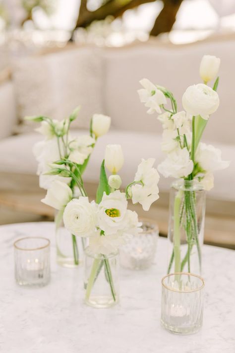 https://freshweddingsandevents.com/ Instagram: @FreshWeddings_CHS Green And White Bud Vases, White Bud Vase Centerpiece, White And Green Bud Vases, Bud Base Center Piece Round Table, Cocktail Table Bud Vase, Diy Bud Vases Wedding, White Low Centerpieces, Bud Vase White Flowers, Long Table Bud Vases