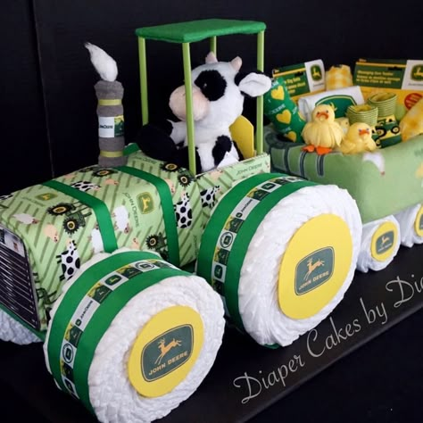 Diana on Instagram: “A John Deer inspired tractor and wagon diaper cake created with John Deere baby items, diapers, fleece blanket and waterproof Change Pad…” Diaper Tractor, Tractor Diaper Cake, Tractor Baby Shower, Diaper Crafts, John Deere Baby, Unique Diaper Cakes, Diaper Gifts, Farm Baby Shower, Diaper Cake Ideas