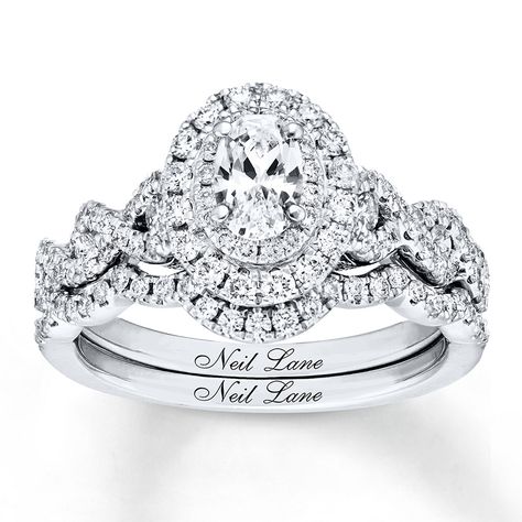 Neil Lane Bridal® rings feature modern, vintage-inspired designs that celebrate Hollywood glamour. This engagement ring showcases a 1/2 carat oval diamond as the brilliant center of attention. Sparkling round diamonds encircle the center and beautifully decorate the band of 14K white gold. Additional round diamonds line the matching contoured wedding band. The bridal set has a total diamond weight of 1 1/3 carats. Diamond Total Carat Weight may range from 1.29 - 1.36 carats. Neil Lane Bridal Set, Bridal Diamond Ring, Neil Lane Engagement Rings, Neil Lane, Dream Rings, Vintage Style Engagement Rings, Solitaire Engagement Rings, Gorgeous Rings, Braut Make-up