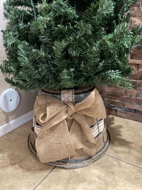 Here is a quick easy Dollar Store tree skirt just in time for Christmas. I have a few trees in my house and I didn’t want to spend money on one of the $20 buckets so I came up with this cute, shabby chic farmhouse tree skirt. It is so simple, you won't believe it! What you’ll need:Laundry basketRibbon (I used lace and burlap but you could use anything)Spray paint (sliver)Black paintRopeScissorsWaverly wax - clear Start by painting the basket sliver. I used this spray paint which is… Laundry Basket Tree Collar Diy, Laundry Basket Tree Collar, Farmhouse Tree Skirts, Tree In Basket, Basket Tree, Christmas Tree In Basket, Cheap Christmas Trees, Farmhouse Tree, Burlap Tree Skirt