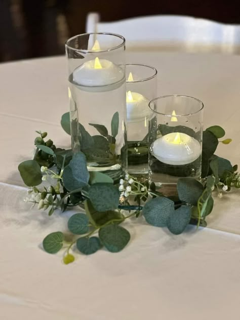 Simple Greenery For Wedding Tables, Ivy And Candle Centerpieces, Green Candle Centerpieces, Simple Green Wedding Centerpieces, Wedding Table Centerpieces Eucalyptus, Greenery Centerpiece Wedding Round Table, Wedding Table Centerpieces Candles And Greenery, Vine Table Decor, Eucalyptus Round Table Decor