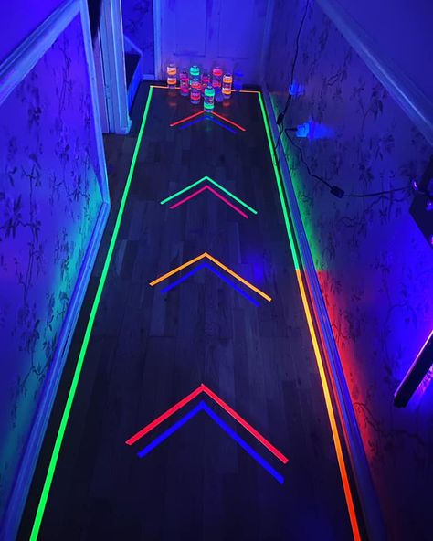 Mum turns her hallway into a glow-in-the-dark bowling alley using water bottles and Amazon bargains Glow In The Dark New Years Eve Party, Glow Party Floor Design, Glow In The Dark Gamer Party, Glow In The Dark Lights, Glow In The Dark Outfit Ideas Neon, Neon Glow In The Dark Party Ideas Food, Neon Party Ideas Games, Neon Glow Party Games, Glow In The Dark Bowling Party