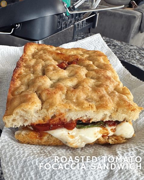 Roasted Tomato Focaccia Sandwich: seasoned roasted tomatoes, basil, and mozzarella on extra-garlicky focaccia bread. Heavenly! Mozzarella Focaccia Bread, Sandwich On Focaccia, Focaccia Bread Sandwich, Foccacia Bread Tomato, Tomato Basil Focaccia Bread, Tomato Mozzarella Foccacia Bread, Foccacia Bread, Roasted Garlic Cloves, Tomato Sandwich