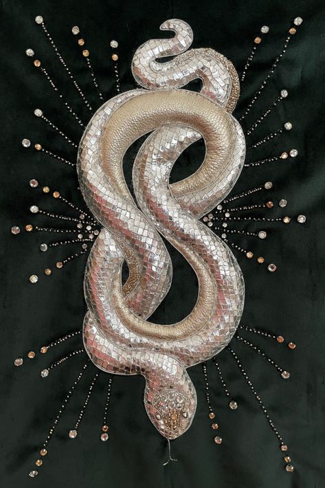 Metallic silver Goldwork snake. Hand embroidery on a green velvet jacket featuring metallic leather, foiled leather and vintage rhinestones.
snake is 3D and curls around realistically. The snake is approximately 10" in length. Snake Jacket, Embroidery On Velvet, Snake Embroidery, Snake Painting, Embroider Ideas, Fuzzy Felt, Leather Embroidery, The Witching Hour, Emb Designs