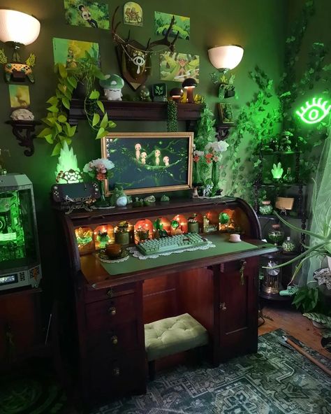 Aureliana Mel Reverie | 💚🌿🌱 . . . . . . . . . . . #cozy #green #fantasy #gamingsetup #cozygamingsetup #gamingdesk #battlestation #setupinspiration… | Instagram Witch Gamer Room, Dream Room Inspiration Green, Spooky Gaming Room, Cottage Core Gamer Setup, Witch Desk Setup, Maximalist Gaming Room, Green Witch Aesthetic Bedroom, Art Room Aesthetic Dark, Green Academia Interior