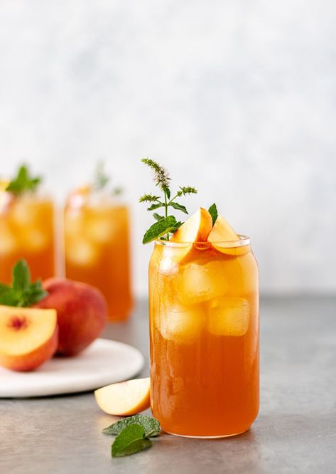 Cool off this summer with this delicious and refreshing peach lavender iced tea. It comes together with a black peach tea, lavender simple syrup, fresh peaches and mint. This tea tastes great and is a big crowd pleaser. | #icedtea #tearecipes #peach #lavender #peachlavender #howisummer #drinks #drinkphotography #summerrecipes #recipesforacrowd #gatherings Ice Tea Photography, Iced Tea Aesthetic, Peach Drink, Peach Iced Tea, Tea Lavender, Iced Tea Recipe, Peach Drinks, Peach Lavender, Tea Restaurant