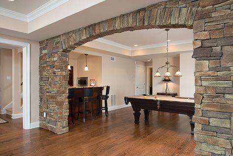 stone with arch...matches adjacent outdoor room... Stone Columns Interior, Interior Design Stone Wall, Accent Stone Wall, Stone Wall Bedroom, Stone Wall Accent, Living Room Stone Wall, Stone Wall Interior, Stone Wall Living Room, Stone Wall Interior Design