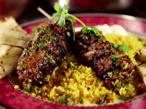 Get this all-star, easy-to-follow Moroccan Beef Kebabs with Curried Couscous, Raita and Charmoula Vinaigrette recipe from Diners, Drive-Ins and Dives Curried Couscous, Arabisk Mad, Moroccan Beef, Diners Drive Ins And Dives, Beef Kebabs, Moroccan Recipes, Beef Kabobs, Vinaigrette Recipe, Ras El Hanout