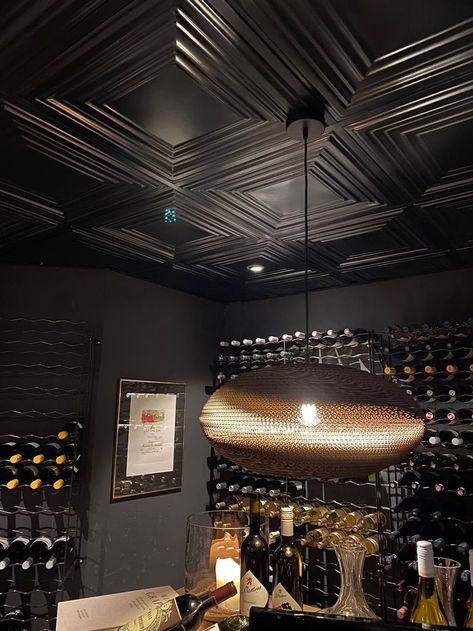 The black steel ceiling tiles from New York Ceiling Co. are robust and warm at the same time. And ideal as original ceiling decor. As in the interior this wine cellar. The metal ceiling tiles come not only in black, but also in copper, brass and other metallic decor. For every interior style the right ceiling tile. Want inspiration for your ceiling ideas? Then take a look at the website for all colors and patterns. The 3d tiles come in different patterns. Black Ceiling Tiles, Copper Ceiling Tiles, Suspended Ceiling Tiles, Ceiling Tiles Basement, Metallic Decor, Metal Ceiling Tiles, Wine Cellar Basement, Modern Restaurant Design, New House Bathroom