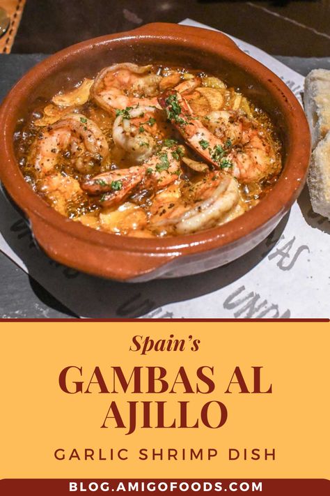 The origins of the Spanish tapa, Gambas al Ajillo, aren’t exactly clear. Some claims trace it back to Al Ajillo, which is a famous meal in all Spanish-speaking countries. They started cooking it in Mexico using garlic and guajillo chili peppers. It’s believed that the Spanish folks wanted to create their own version of the plate, thus the use of shrimps. #spanishfood #spain #tapas #shrimp #amigofoods #recipes Shrimp In Garlic Sauce Spanish, Shrimp Al Ajillo, Shrimp Ajillo Recipe, Spanish Garlic Shrimp Recipes, Spanish Shrimp Tapas, Spot Shrimp Recipes, Shrimp Tapas Recipes, Spanish Seafood Recipes, Spanish Shrimp Recipes