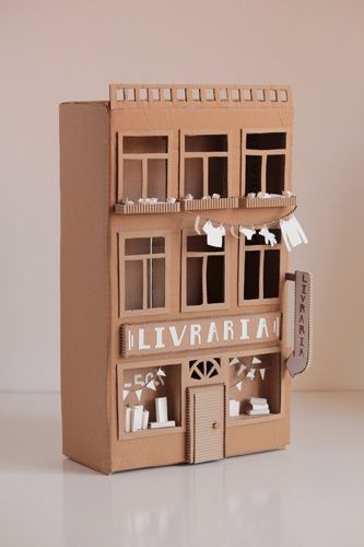 Cardboard bookshop Carton Crafts Cardboard, Cardboard Library, Portuguese Buildings, Small Cardboard House, Cardboard Buildings, Cardboard Building, Cardboard Doll, Cardboard Box Houses, Cardboard Book