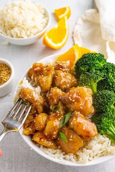 Lighter orange chicken has tender pieces of chicken that's coated in a sweet, sticky, orange flavored sauce that's better than take-out. #glutenfreerecipe #orangechicken #chinesefood #takeoutfakeout #chickenrecipe #weeknightmeals #easyrecipe #onepanmeal | robustrecipes.com Orange Chicken Over Rice, Chinese Orange Chicken Recipes Easy, Healthier Orange Chicken, Easy Orange Chicken Recipe Simple, Orange Chicken Panda Express, Crunchy Fried Chicken, Chicken A L'orange, Panda Express Orange Chicken, Orange Chicken Sauce