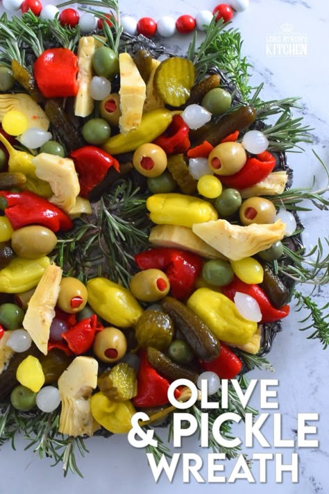 This bright and shiny edible wreath is packed full of sweet, salty, and tangy flavour! Consisting of your favourite pickled and marinated foods, an Olive and Pickle Wreath is the answer to every host's holiday appetizer table. Assemble on a platter and refrigerate until ready to serve. It's easy, delicious, and festive! #olives #pickles #charcuterie #christmas #holiday #partyfood Christmas Olive Wreath, Cheese And Pickle Charcuterie Board, Olive Pickle Platter, Pickle Wreath, Pickle Olive Tray, Relish Tray Ideas For Christmas, Christmas Relish Tray Ideas, Christmas Relish Tray, Pickle And Olive Tray Ideas