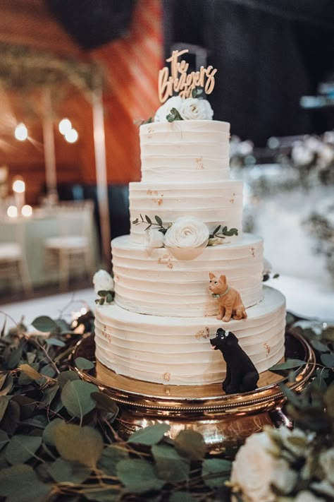 A white wedding cake with miniature figures of their cat and dog sitting on two of the tiers. | Photo: Ama by Aisha | #weddinginspo #weddingcake #cakeinspo #cutecakeideas #weddingideas #petsinwedding #dogsinwedding #weddingcakeideas #whiteweddingcake #classiccake Dog And Cat Wedding Cake Topper, Animals On Wedding Cake, Wedding Cake Animals, Musical Wedding Cake, Wedding Cake With Cat Peeking Out, Cat Wedding Cake Ideas, Wedding Cake With Figures, Wedding Cakes With Cats, Wedding Cake With Dogs On It