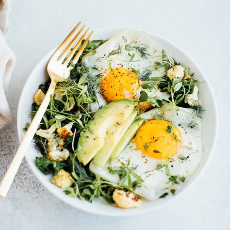 A simple, delicious breakfast bowl (aka breakfast salad) with sautéed greens and two fried eggs! You'll feel so good after starting your day with this combo of protein, healthy fat and veggies. Low carb, gluten-free and vegetarian.