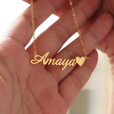 "Custom Name Necklace with Heart,Rose Gold Name Necklace,Dainty Name Necklace,Unique Name Necklace,Minimalist Necklace,Birthday Day Gift ✨Description 1、Color: gold plated, rose gold plated, silver 2、Chain length: 14 \", 16\", 18 \", 20\", 22 \" 3、Gift box: All our necklaces are preparing gifts in elegant jewels, ready to use as gifts. ✨How to order? 1、Select necklace color and material 2、Select necklace length 3、Leave the content you want to customize in the custom box 🎁Transportation time 1、Our manual time is 3-5 working days 2、The transportation time is 8-10 working days, and the working day outside Australia is 8-12 working days. 🌈About jewelry 1、 Don't leave a wet environment for a long time 2、 Avoid contact with perfume, body oil and other chemicals 3、 Do not use chemical cleaner 🙌 Customize Name Necklace, Name Necklace With Heart, Name Pendent Designs, Name Chain Gold, Gold Necklace With Name, Necklaces With Names, Jewelry Names, Kalung Choker, Name Chain