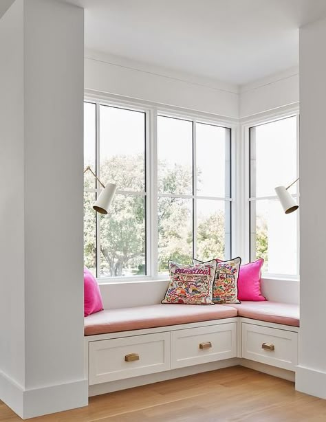 Cute l-shaped window seat with pink cushions creates a perfect place to pick up a book and lounge under natural light from tall windows in a girls bedroom. Bay Seating, Reading Nook Cozy Corner, Corner Window Seat, Window Seat Nook, Bedroom Window Seat, Window Seat Ideas, Window Bench Seat, Window Seat Design, Window Bench