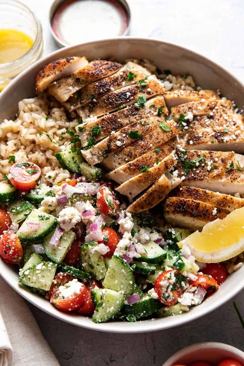 These greek chicken bowls are an easy and healthy summer dinner. Tender greek seasoned chicken and fluffy brown rice are served with an english cucumber salad made up of cherry tomatoes, feta cheese, red onion, parsley and a homemade vinaigrette. English Cucumber Salad, Fluffy Brown Rice, Cherry Tomatoes Feta, Greek Chicken Bowls, Healthy Summer Dinner, Greek Chicken Pasta, Homemade Vinaigrette, Greek Chicken Salad, Chicken Bowls