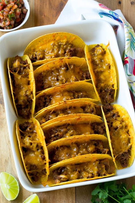 Baked beef tacos topped with melted cheese in a casserole dish. Bake Tacos, Tacos In The Oven, Baked Beef Tacos, Tasty Tacos Recipe, Oven Baked Tacos, Pulled Chicken Tacos, Baked Tacos, Oven Tacos, Ground Turkey Tacos