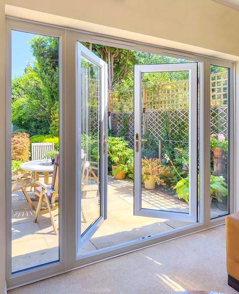 French patio doors with side windows can transform your living space with more natural light.. Backyard Double Doors, French Doors From Bedroom To Patio, Replacing Sliding Door With French Doors Patio, Living Room With Garden Doors, Patio With French Doors, Large French Doors Patio, Folding Patio Doors With Screen, Backyard French Doors, Large Glass Doors To Patio