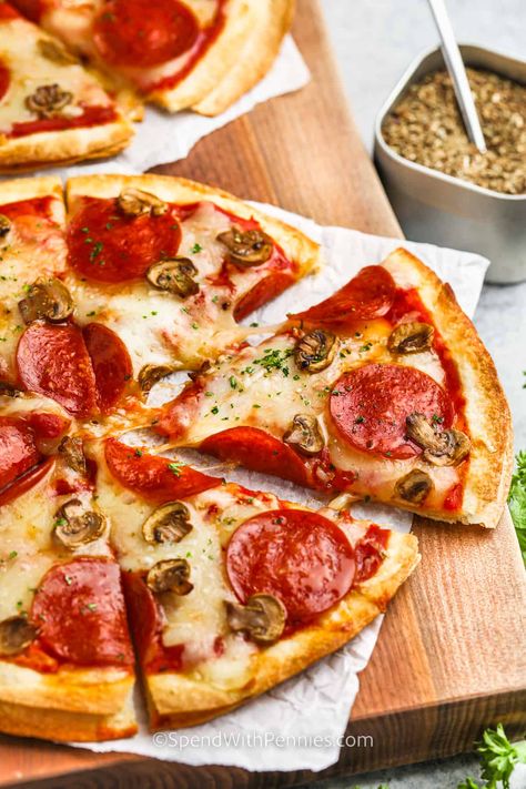 Tortilla pizza is a quick and delicious twist on traditional pizza. Using tortillas as the base, you can easily add sauce, cheese, and your favorite toppings. In just a few minutes, you'll have a crispy personal-sized pizza ready to enjoy. It's a fun and customizable meal for anytime cravings. #tortillapizza #easyrecipe #howtomake #spendwithpennies Tortilla Pizzas, Easy Pizza Crust, Homemade Italian Seasoning, How To Make Tortillas, Leftover Pizza, Tortilla Pizza, Pizza Sauce Homemade, Making Homemade Pizza, Perfect Pizza