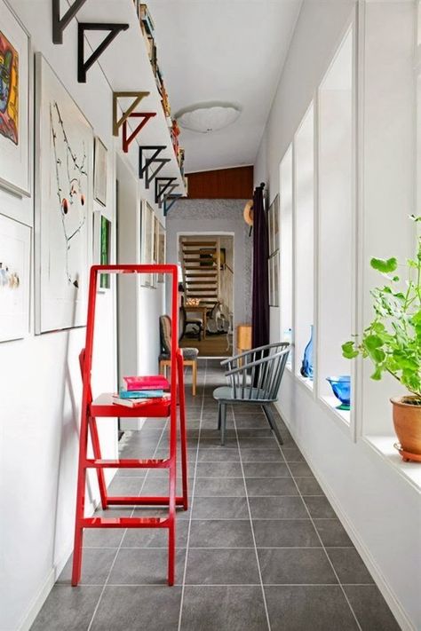 For a little extra storage, mount a shelf just below the ceiling along the length of a room. If your ceilings are tall enough, you'll barely notice it. This works especially well in a hallway, as spotted on Hus & Hem. Small Hallway Ideas, Space Apartments, Small Entryways, Hallway Storage, Small Entryway, Small Hallways, Small Space Solutions, Narrow Hallway, Big Ideas