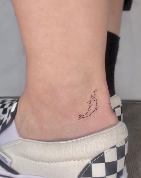 Small 4 Tattoo, Ankle Dolphin Tattoo, Earth Related Tattoos, Tiny Dolphin Tattoo Simple, Dolphin Tattoo On Ankle, Fine Line Tattoo Dolphin, Dolphin Tattoo For Men, Wouldve Couldve Shouldve Tattoo, Dolfin Tattoo Minimalist