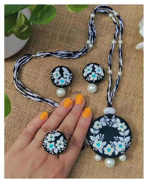 Meraki 🌼 New launch Wednesday🌼 Week 6🧿 Elegance in every detail 🌸 Don't forget to Swipe up👈 This handcrafted jewelry set features delicate floral embroidery on a deep teal base, paired with pearls for a timeless touch. Perfect for adding a unique charm to your outfit. 🤍 Details - Adjustable Neckpiece, Drop stud and ring set 🤍 Shade - Deep teal 🤌 Customisation - Available (in any color of your choice) 🫶 DM to know more 🌸 . . . . . . . . . . . [New launch, jewelry collection, handmade jewelry, ... Embroidery Ring Designs, Embroidered Jewelry Handmade, Embroidery Jewellery Handmade, Hand Embroidery Jewelry, Embroidery Jewellery, Embroidery Pendant, Hand Embroidered Jewelry, Embroidery Hoop Art Diy, Diy Fabric Jewellery