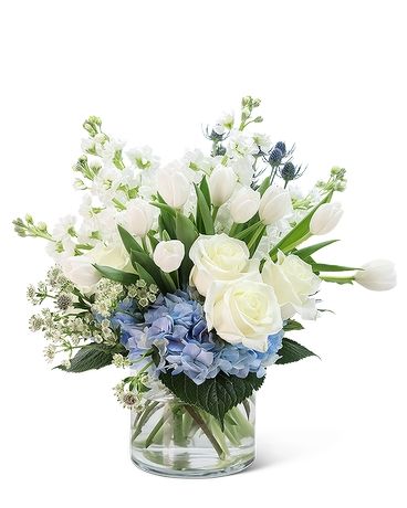 Doesn't everyone need a Breath of Fresh Air delivered to their day? Everyone around will appreciate the beauty and fragrance of this magnificent floral design. This refreshing floral arrangement features long-lasting white roses, tulips, hydrangea, stock, astrantia, and eryngium. A Breath of Fresh Air is the perfect gift for a birthday, get well, or anniversary present to make your loved one feel extra special. Blue And White Vases With Flowers Floral Arrangements, Blue And White Table Arrangements, Blue And White Flower Arrangements Centerpieces, Baby Boy Shower Flower Arrangements, Blue Hydrangea Flower Arrangements, Ginger Jar Floral Arrangements, White And Blue Floral Arrangements, White And Blue Centerpieces, White And Blue Flower Arrangements