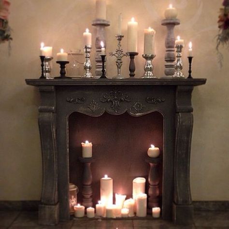 a vintage fireplace with pillar candles and vintage candle holders in the fireplace and on the mantel Mantel Candles, Gothic Fireplace, Evil Lair, Faux Fireplace Diy, Vintage Fireplace, Candles In Fireplace, Goth Home, Faux Fireplace, Candle Displays