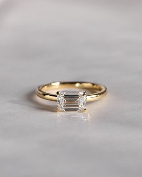 This stunning 1.75 CT emerald cut moissanite engagement ring embodies classic Art Deco elegance. Handcrafted by skilled artisans, this bridal ring features a brilliant moissanite, a superior diamond alternative known for its exceptional sparkle and durability. A timeless choice for weddings, anniversaries, or promises. Sideways Rectangle Engagement Ring, Horizontal Emerald Engagement Ring, Horizontal Engagement Ring, Rectangle Engagement Rings, Classic Wedding Ring, Engagement Ring Art Deco, Engagement Ring Ideas, Blood Diamond, Classic Wedding Rings