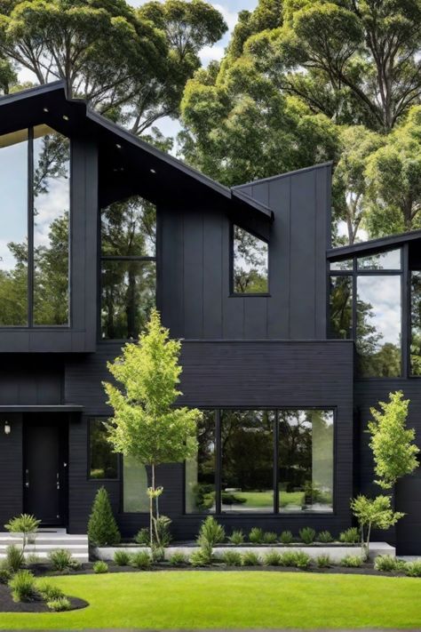 Modern black house with large windows, surrounded by lush greenery and trees. Dark House Landscaping, Charcoal Home Exterior, Black Mid Century House, House Design Dark, Home Exterior Black, Black Exterior Paint Colors, Black Contemporary House, All Black Houses, Black Houses Exterior