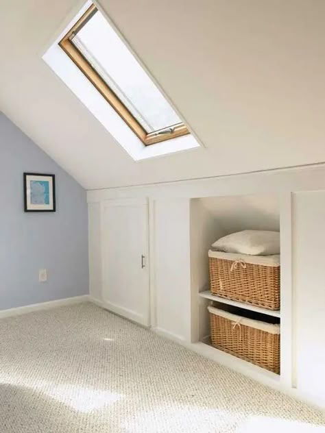 a pretty neutral attic room with built in storage   baskets for storage and storage compartments with doors is amazing Build Attic Storage, Eaves Clothes Storage, Built In Drawers Under Eaves, Storage In Attic Space, Attic Bathroom Closet Combo, Loft Built In Storage, Pitched Ceiling Storage, Attic Built In Shelves, Sloped Ceiling Storage Built Ins