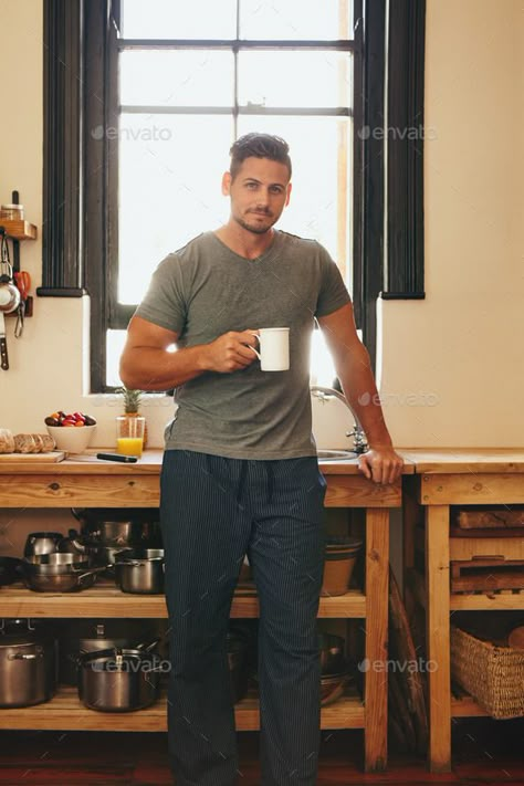 Young man having refreshing coffee in morning by jacoblund. Portrait of young man standing in kitchen holding a cup of coffee. Handsome male model having fresh morning coffee at... #AD #jacoblund, #morning, #young, #Portrait Holding A Coffee Cup Pose, Holding Cup Pose Reference, Holding Coffee Pose Reference, Person Holding Coffee Cup, Home Photoshoot Ideas Men, Holding Cup Pose, Person Holding Coffee, Holding Coffee Pose, Drinking Coffee Pose Drawing