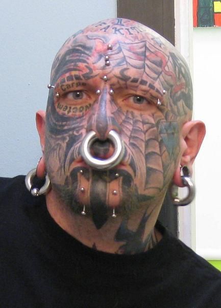 Full face tattoo, piercings, extreme body modification Full Face Tattoo, Weird Piercings, Piercing Face, Human Oddities, Web Tattoo, Septum Piercings, Scary Faces, Bad Tattoos, Inked Magazine