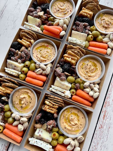 Individual Charcuterie Boxes (also known as grazing boxes) are loaded with sweet and savory treats that make great gifts for any occasion. Fill your grazing box with a variety of nuts, cheeses, fruits and chocolate, and watch the smiles appear! Charcuterie Boxes Individual, Traveling Charcuterie Board, Charcuterie Basket Ideas, Chartucherie Ideas, Single Serving Charcuterie, Grab And Go Market, Charcuterie Lunch Box Ideas, Charcuterie Store, Individual Charcuterie Box Ideas