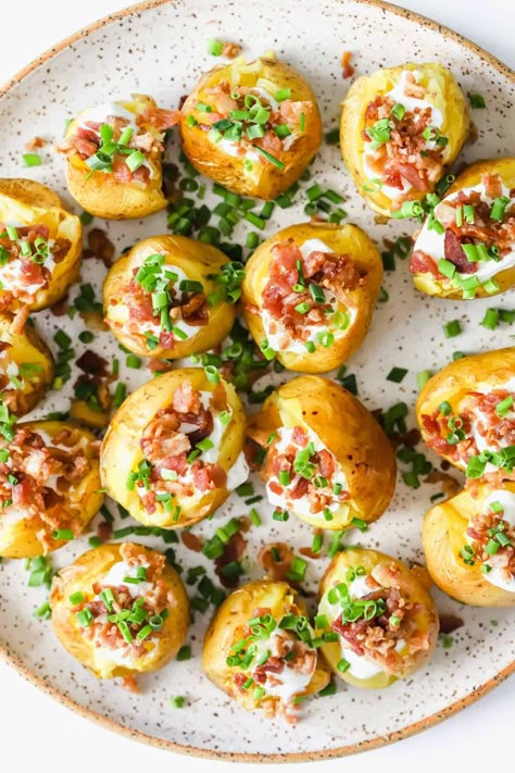 Mini Baked Potatoes are the perfect bite-sized snack that packs a punch of flavor! They’re crispy on the outside, tender on the inside, and topped with cool sour cream, bacon bits, and fresh chives. Serve them as a crowd-pleasing appetizer or side dish at your next gathering! Baked Potato Cups, Gathering Appetizers, Stuffed Potato Appetizer, Baked Potato Bites, Baked Potato Appetizer, Loaded Mini Potatoes, Baked Potatoes Charcuterie Board, Twice Baked Potato Appetizer, Mini Loaded Potatoes