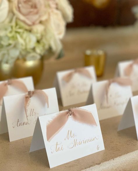 Tented place cards with calligraphy and gold ink. Tent Place Cards Wedding, Champagne Place Cards Wedding, Place Card With Ribbon, Wedding Placecard Table Sign, Name Cards With Ribbon, Bridal Shower Place Cards Ideas, Seating Cards Ideas, Wedding Name Cards Diy, Meal Indicator Place Cards