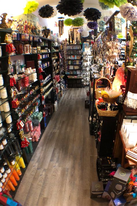 This section of the store showcases our hoodoo oils, saint and angel oils, rootwork supplies, spell candles, and tarot cards on the far end. #newagestore #metaphysicalstore Psychic Store, Spiritual Store Ideas, Botanica Store, Metaphysical Shop Ideas, Witchy Store, Witchcraft Store, Spiritual Oils, Crystal Waist Beads, Witch Store