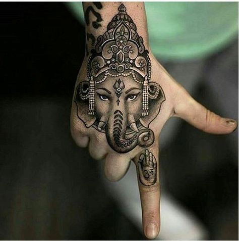 23. Indian lucky charm on the hand This distinctive piece of art on the hand shows an ornate elephant with a traditional Indian sign on its forehead, the icon of a hand on the forefinger is an amusing detail. The tattooing is about a true sense of mindfulness. - source Elephant Tattoo On Hand, Ganesha Tattoos, Hand Tattoo Men, Indian Elephant Tattoo, Cute Elephant Tattoo, Hindu Tattoos, Ganesh Tattoo, Tato Tradisional, Elephant Tattoo Design