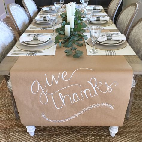 Thanksgiving easy table setting. Kraft paper runner.  Magnolia home placemats. Fresh eucalyptus and candles Thanksgiving Craft Paper Table Runner, Diy Friendsgiving Decor, Friendsgiving Table Setting Disposable, Simple Dinner Party Table Decor, Thanksgiving Set Up For Large Family, Cricut Thanksgiving Projects For Table, Mexican Thanksgiving Decor, Brown Paper Thanksgiving Table, Black And White Thanksgiving Tablescapes