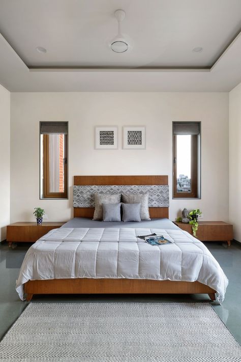 A three-level bungalow in Vadodara designed for a traditional Gujarati joint family | Architectural Digest India Indian Home Bedroom, Modern Bedroom Window Design, Indian Traditional Bedroom Ideas, Kerala Bedroom Interior Design, Traditional Indian Bedroom Design, Bed Near Window, Bedroom With Window, Traditional Bedroom Ideas, Bedroom Window Design