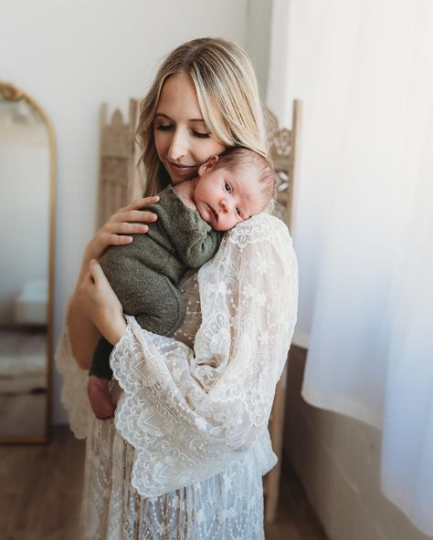 A new mother in a lace gown holds her baby boy on her shoulder as he looks straight at the viewer. Newborn Photography Single Mom, In Nursery Newborn Photos, Christmas Newborn Photoshoot Family, Newborn Photography Natural, Newborn Photography Girly Family, Cozy In Home Newborn Session, Mom And Newborn Photography, Newborn Photography Mom, Newborn Family Photos At Home