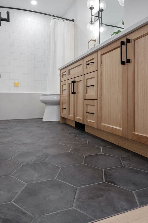 Galley Kitchen Floor Tile, Bathroom Vanity And Floor Ideas, Black White Gray Wood Bathroom, Bathroom And Kitchen Tile Floor, Bathroom Gray Floor White Vanity, Bathroom Design Black Floor, Bathroom Remodel Honeycomb Tile, Textured Bathroom Floor, Dark Hexagon Bathroom Floor